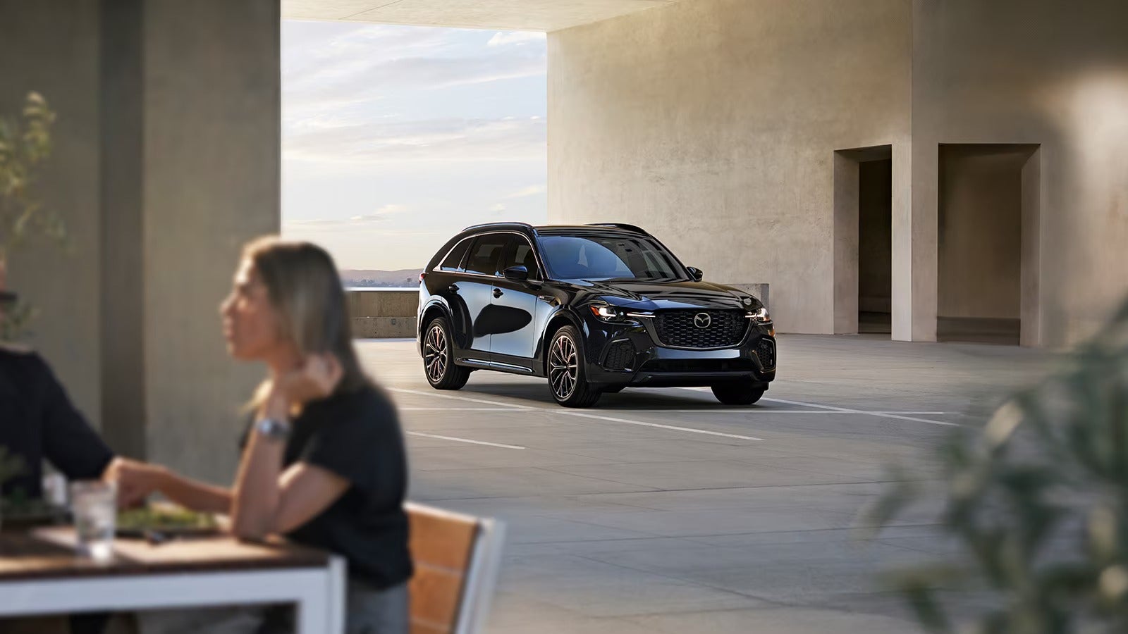 dark CX-70 parked in front of a cafe from Fitzgerald Mazda Frederick in Frederick MD 